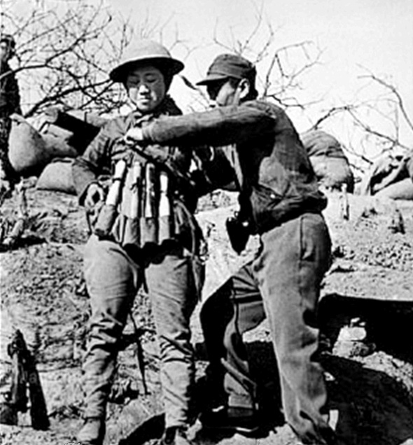 Chinese_infantry_soldier_preparing_a_suicide_vest_of_Model_24_hand_grenades_at_the_Battle_of_Taierzhuang_against_Japanese_Tanks.jpg